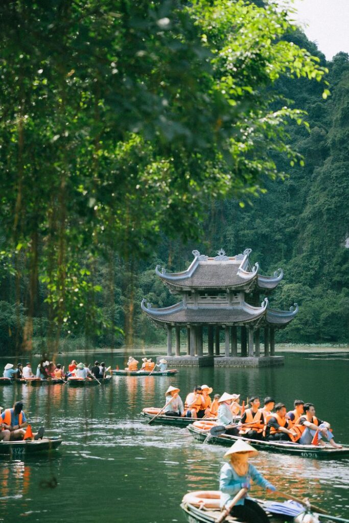 Explore the tranquil waterways of Ninh Bình with lush greenery and traditional architecture.